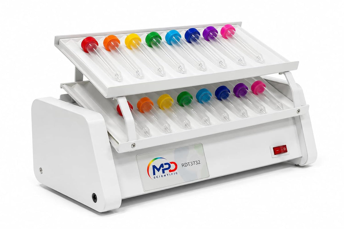 A white scientific tube rocker with two angled racks holding clear plastic tubes, each fitted with a brightly colored cap in red, orange, yellow, green, blue, purple, and pink. The front panel shows the logo 'MPD SCIENTIFIC' and a red power switch.